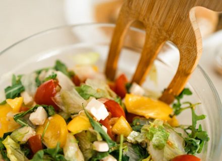 Vibrant vegetable salad with fresh ingredients in a glass bowl, perfect for healthy meals.